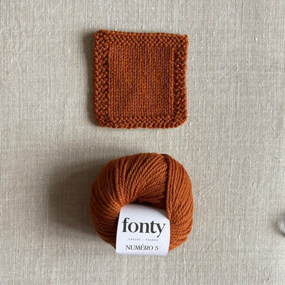 Pelote de laine Numéro 5 coloris écureuil de Fonty – boutique Tricotant, vue de dessus sur fond lin avec échantillon tricoté